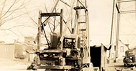 Sepia toned photo of cable tool drilling rig 