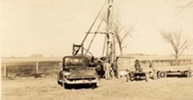 Sepia toned photo of cable tool drilling rig 